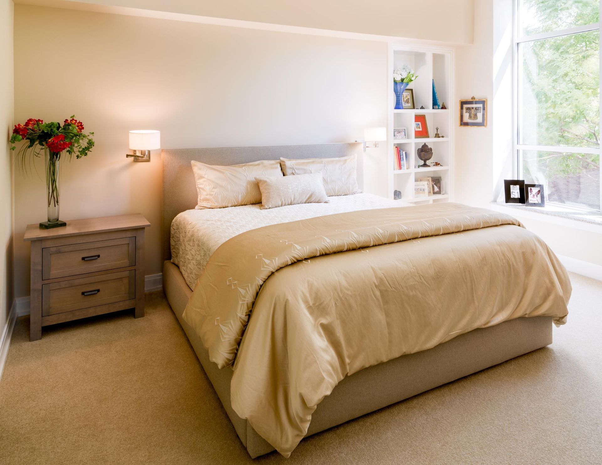 A bedroom with a large bed and a nightstand