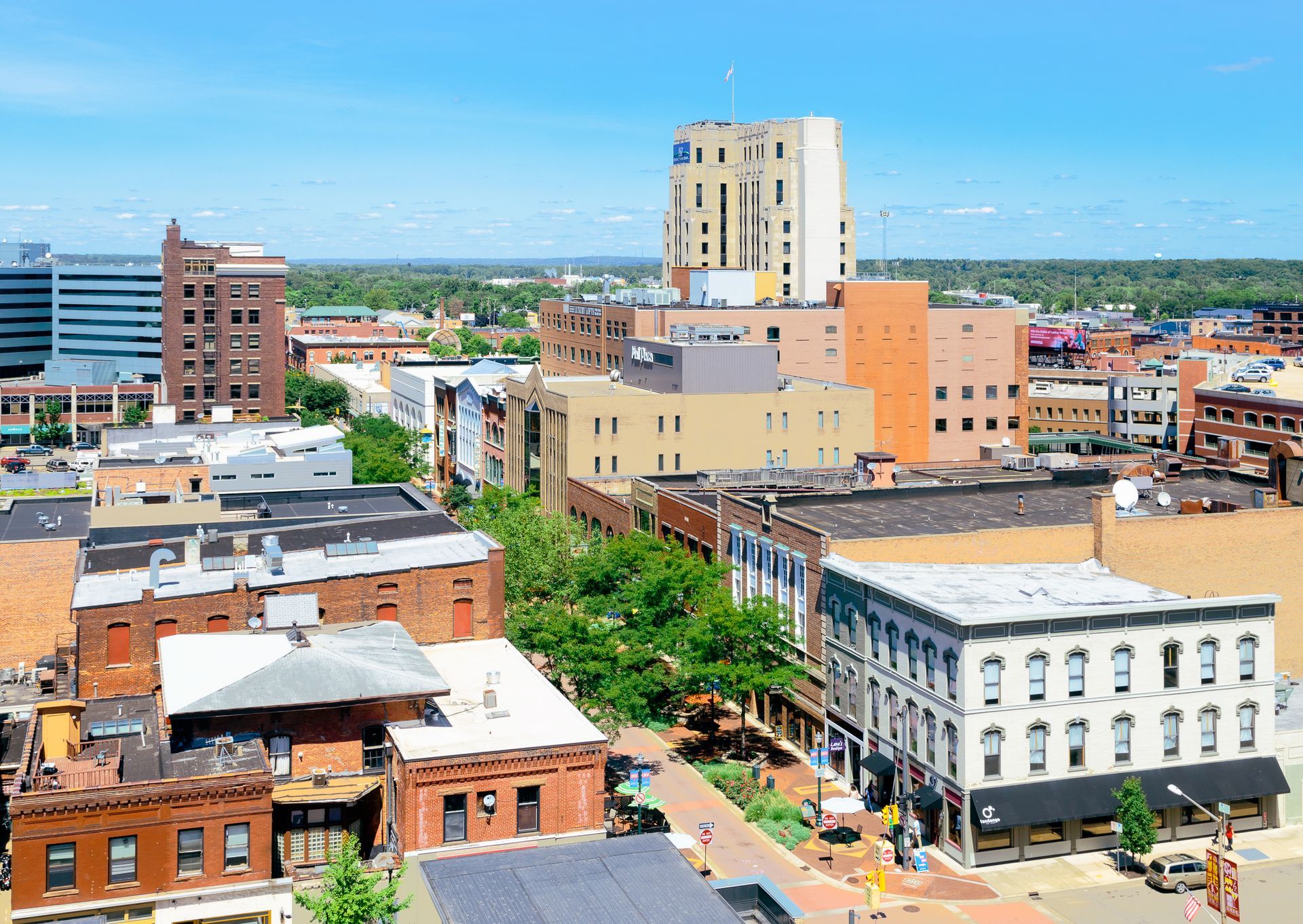 An aerial view of a city with a large building in the background