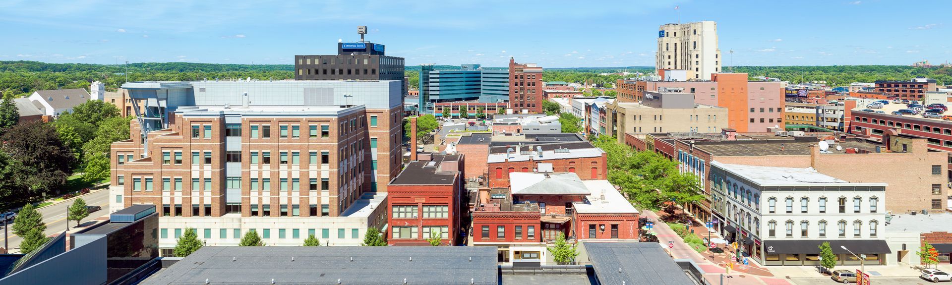 An aerial view of a city with lots of buildings and trees.