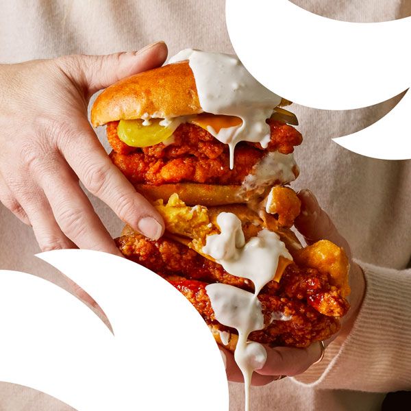 A close up of a person holding a chicken sandwich