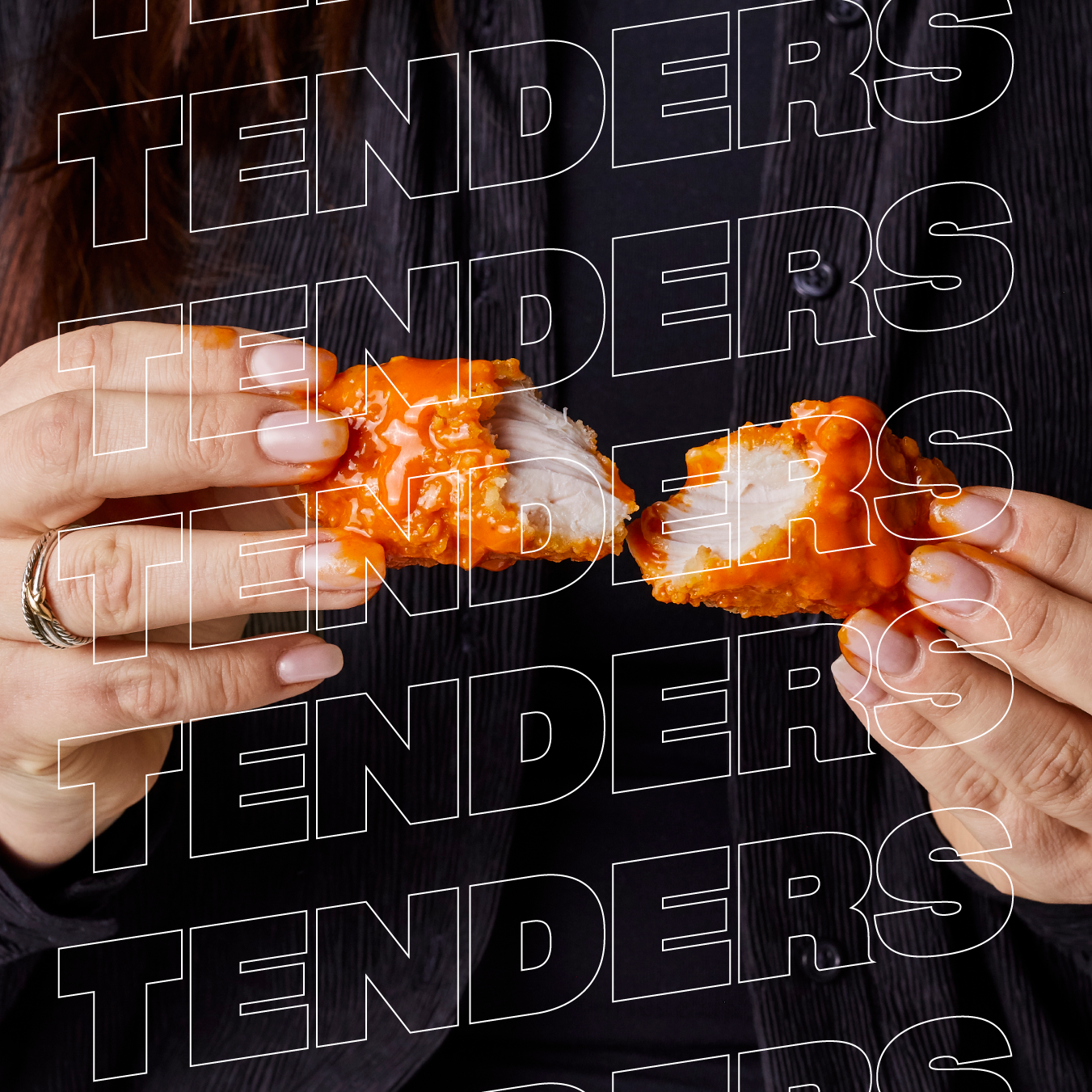 A woman is holding a piece of chicken with the words tenders tenders written on it
