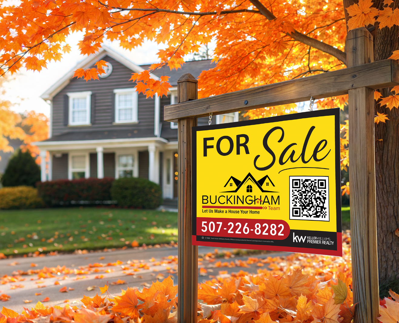 Autumn house for sale with yellow sign and orange leaves in front yard