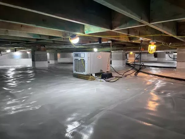 Encapsulated crawl space with vapor barrier, dehumidifier