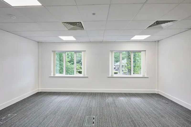 Empty office space with large windows in Oak House at Tanshire Business Park