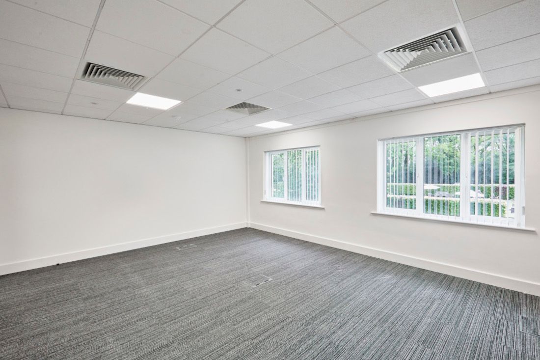 Office space with windows and large lights in Oak House at Tanshire Business Park