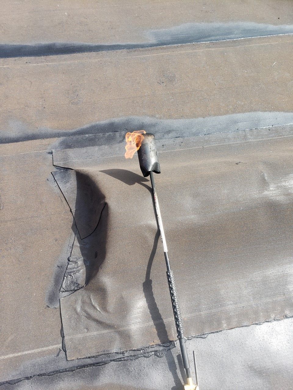 A torch is sitting on top of a concrete surface.