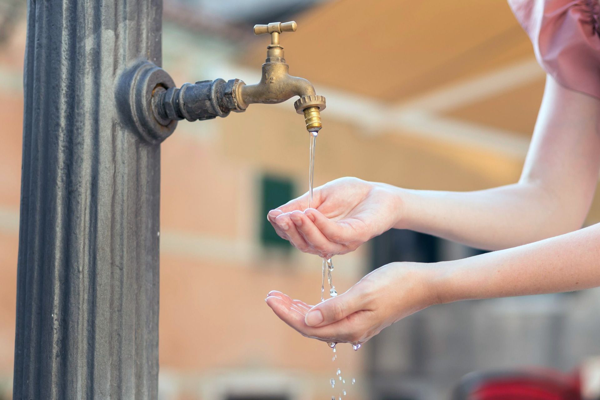 Professional collecting private well water sample