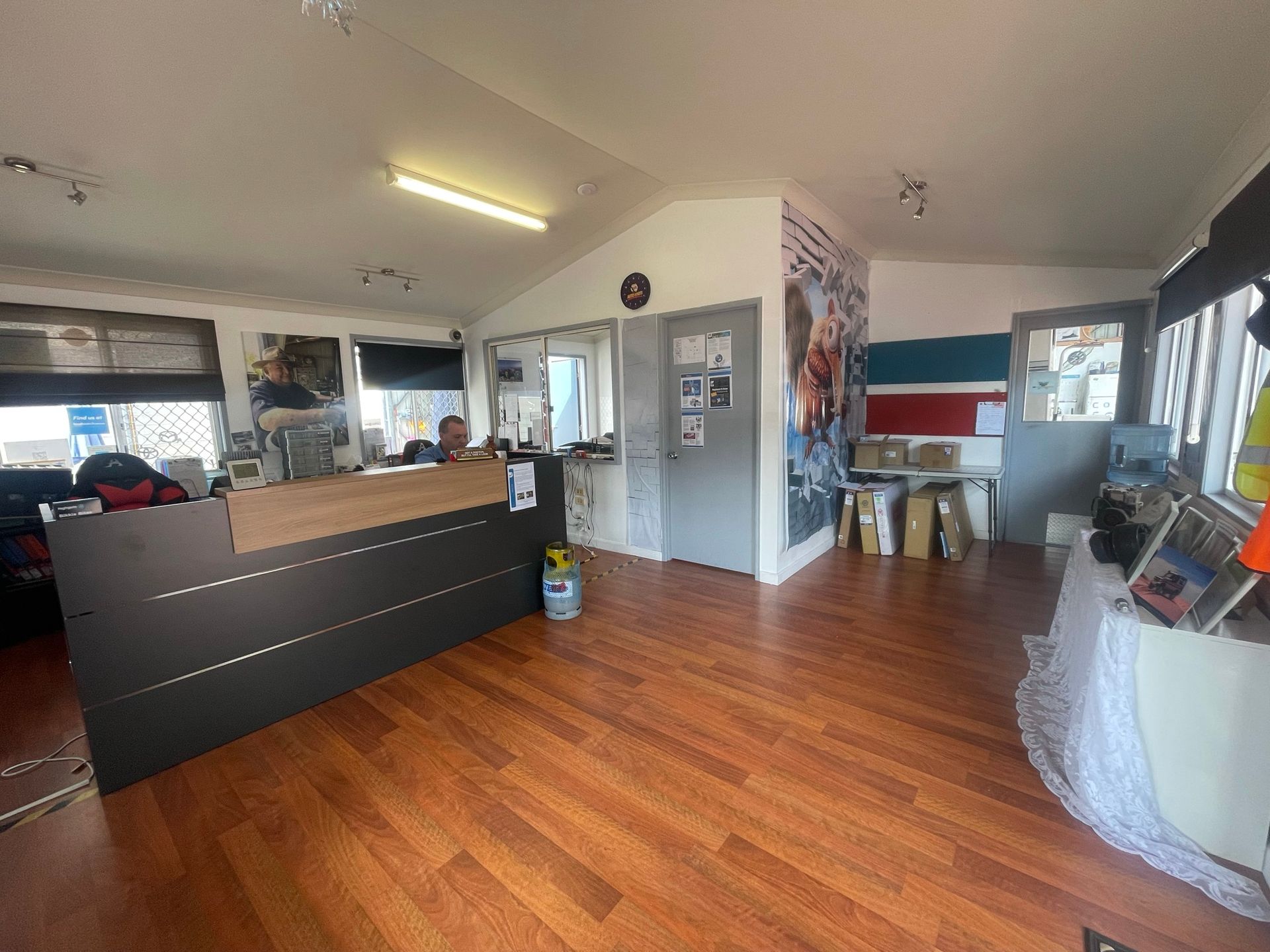 A Reception Desk in a Room With Hardwood Floors — Cool Cats Auto Air in Urangan, QLD