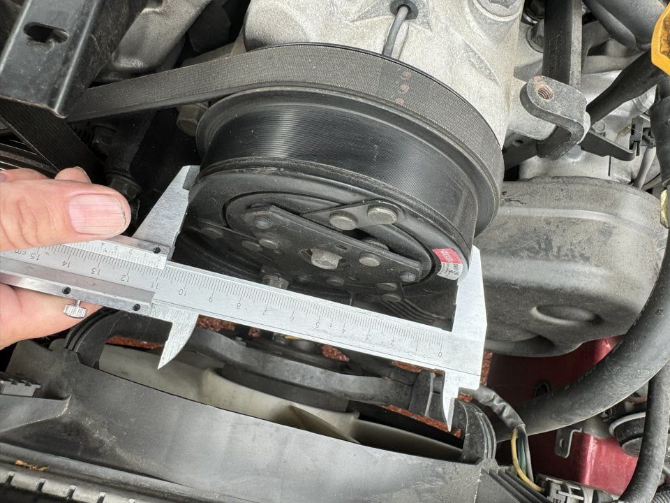 A Person is Measuring a Clutch With a Caliper — Cool Cats Auto Air in Urangan, QLD