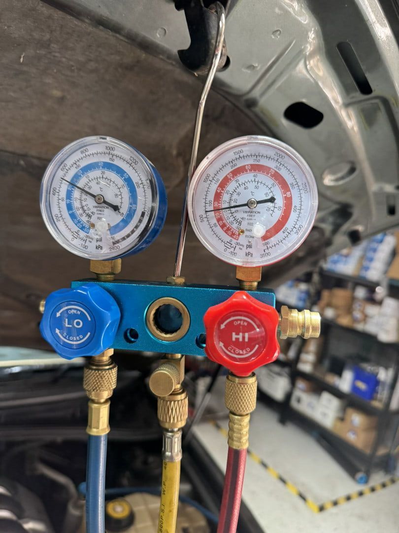 Two Gauges Are Attached to the Hood of a Car — Cool Cats Auto Air in Urangan, QLD