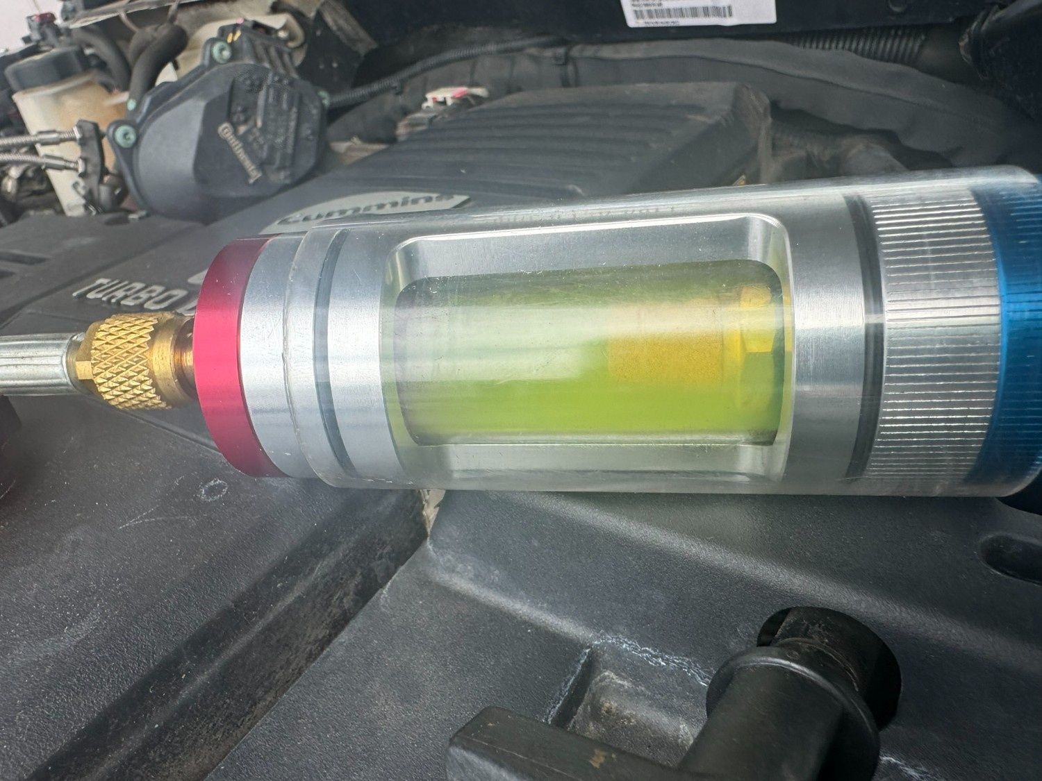 A Clear Cylinder With Yellow-green Liquid — Cool Cats Auto Air in Urangan, QLD
