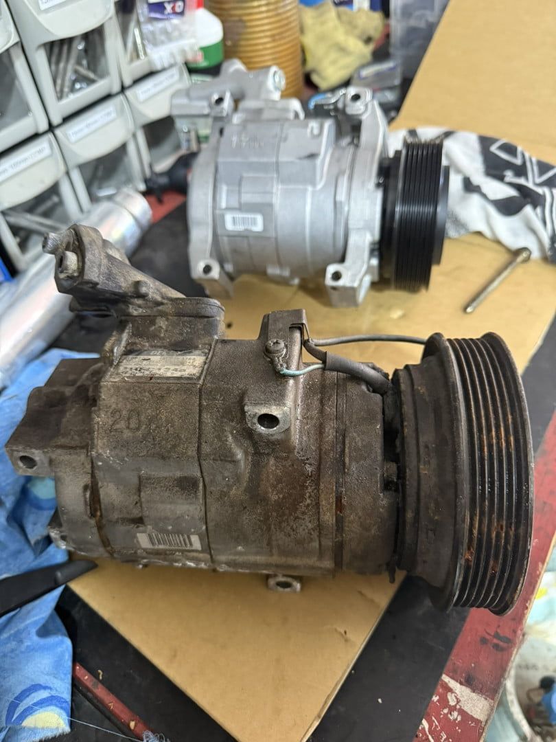 Two Air Compressors Are Sitting on a Wooden Table — Cool Cats Auto Air in Urangan, QLD