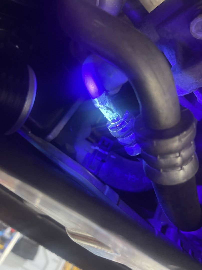 A Blue Light is Shining on a Pipe Under a Car — Cool Cats Auto Air in Urangan, QLD