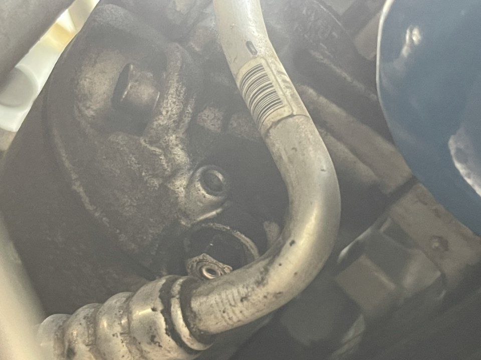 A Close Up of a Hose Attached to a Car Engine — Cool Cats Auto Air in Urangan, QLD