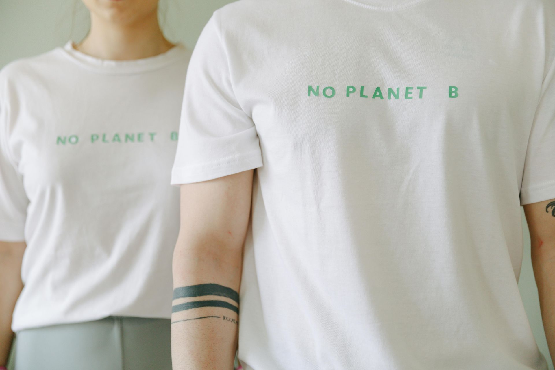 Two people in white t-shirts with the phrase 