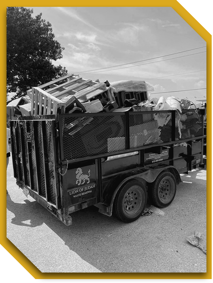 A black and white photo of a dumpster filled with trash