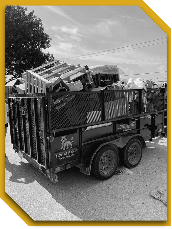 A black and white photo of a dumpster filled with trash