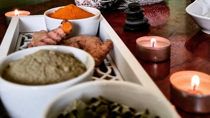 A tray of spices and candles on a table