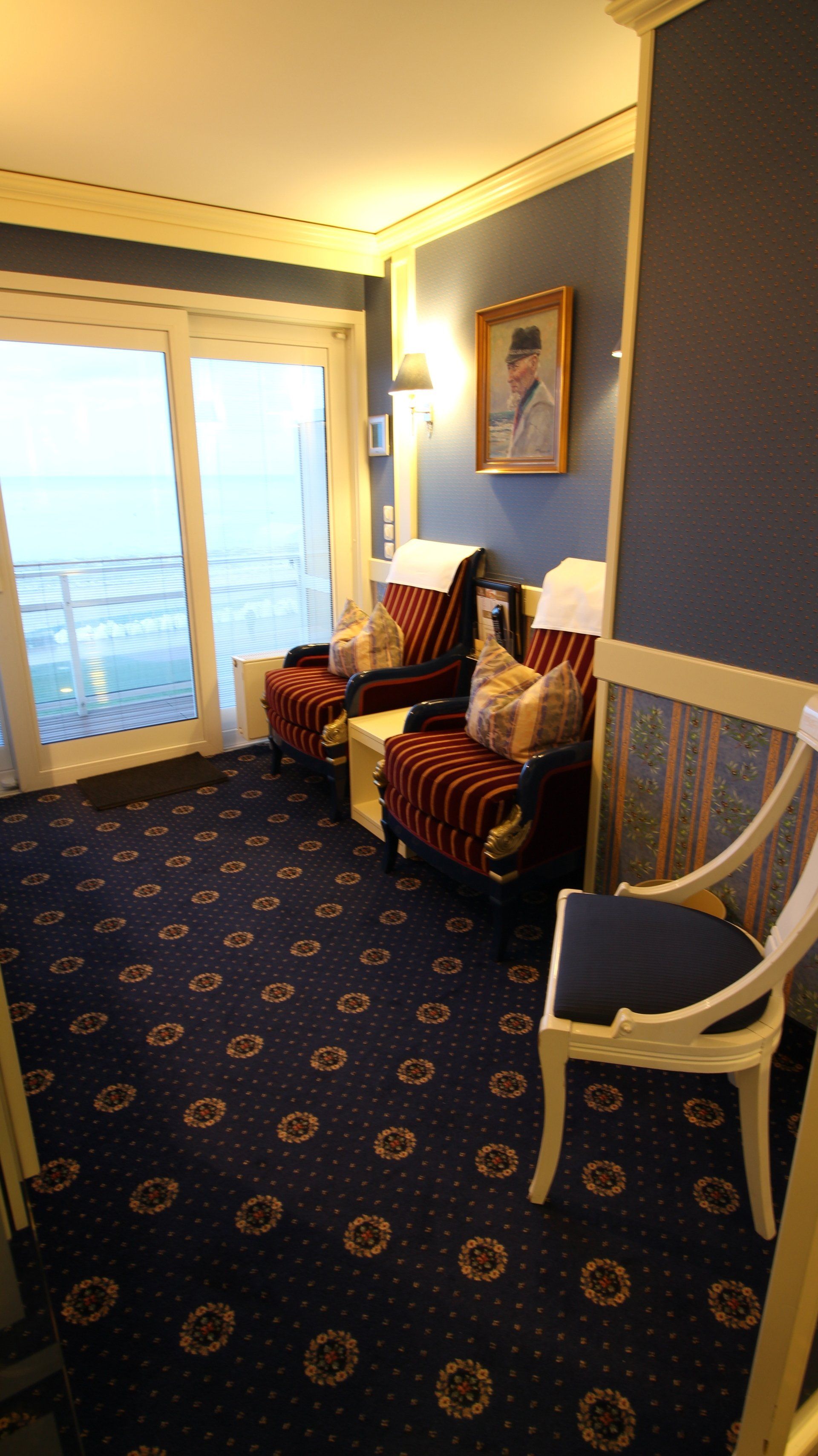 A room with chairs and a painting on the wall