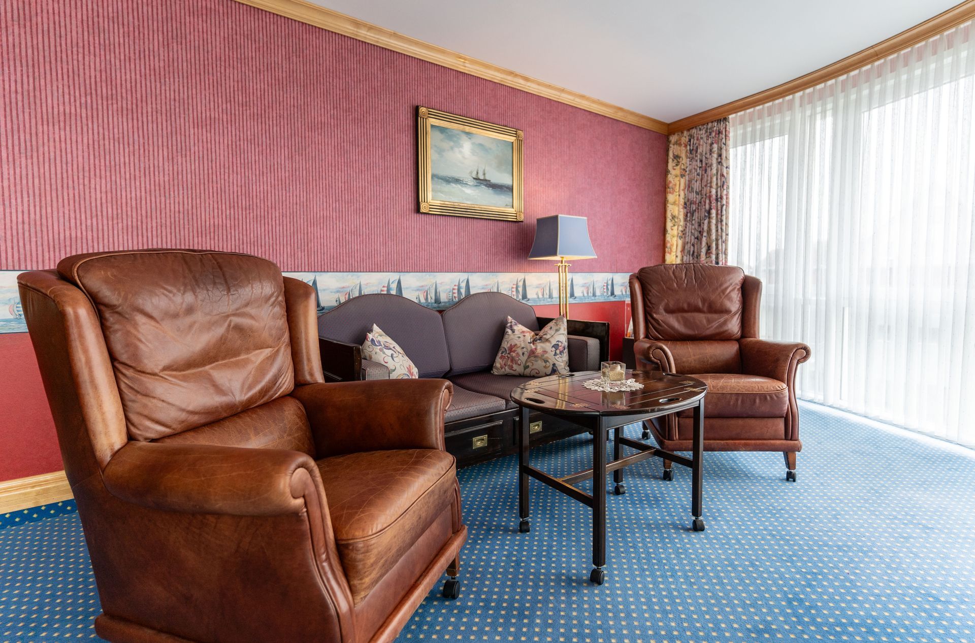 Ein Wohnzimmer mit einem Sofa, Stühlen und einem Tisch.