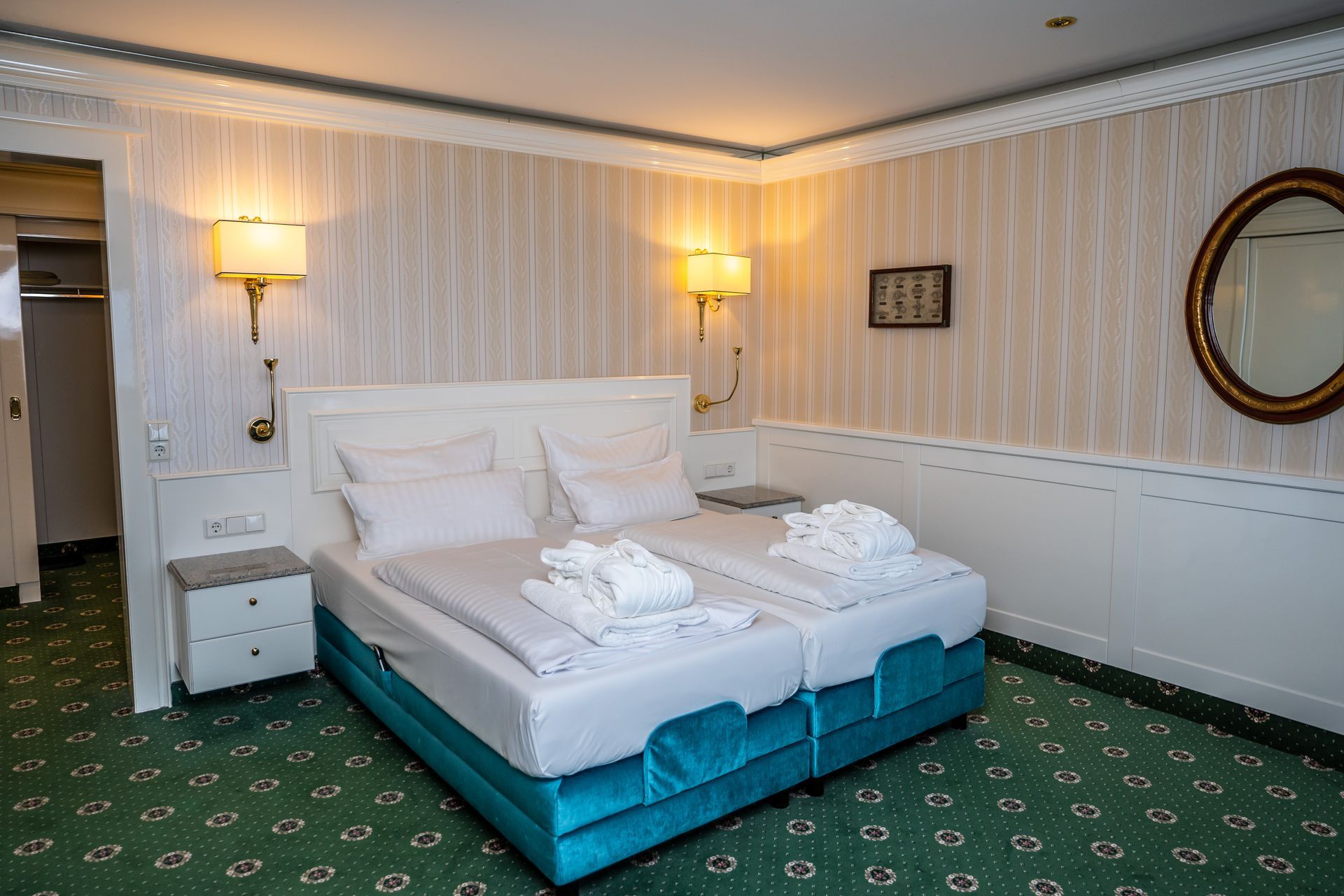 Ein Hotelzimmer mit zwei Betten und einem Spiegel.