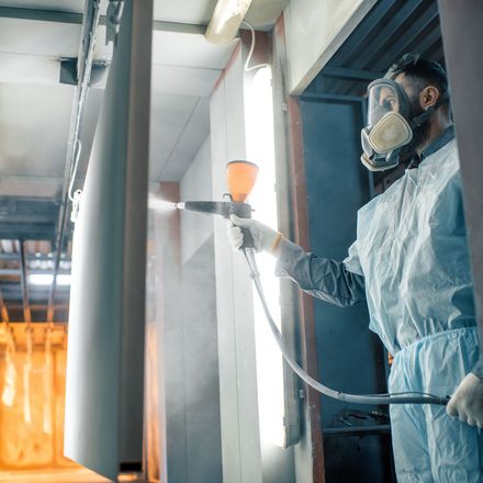 Finish/Powder Coating Factory worker applying a powder coat to stainless steel