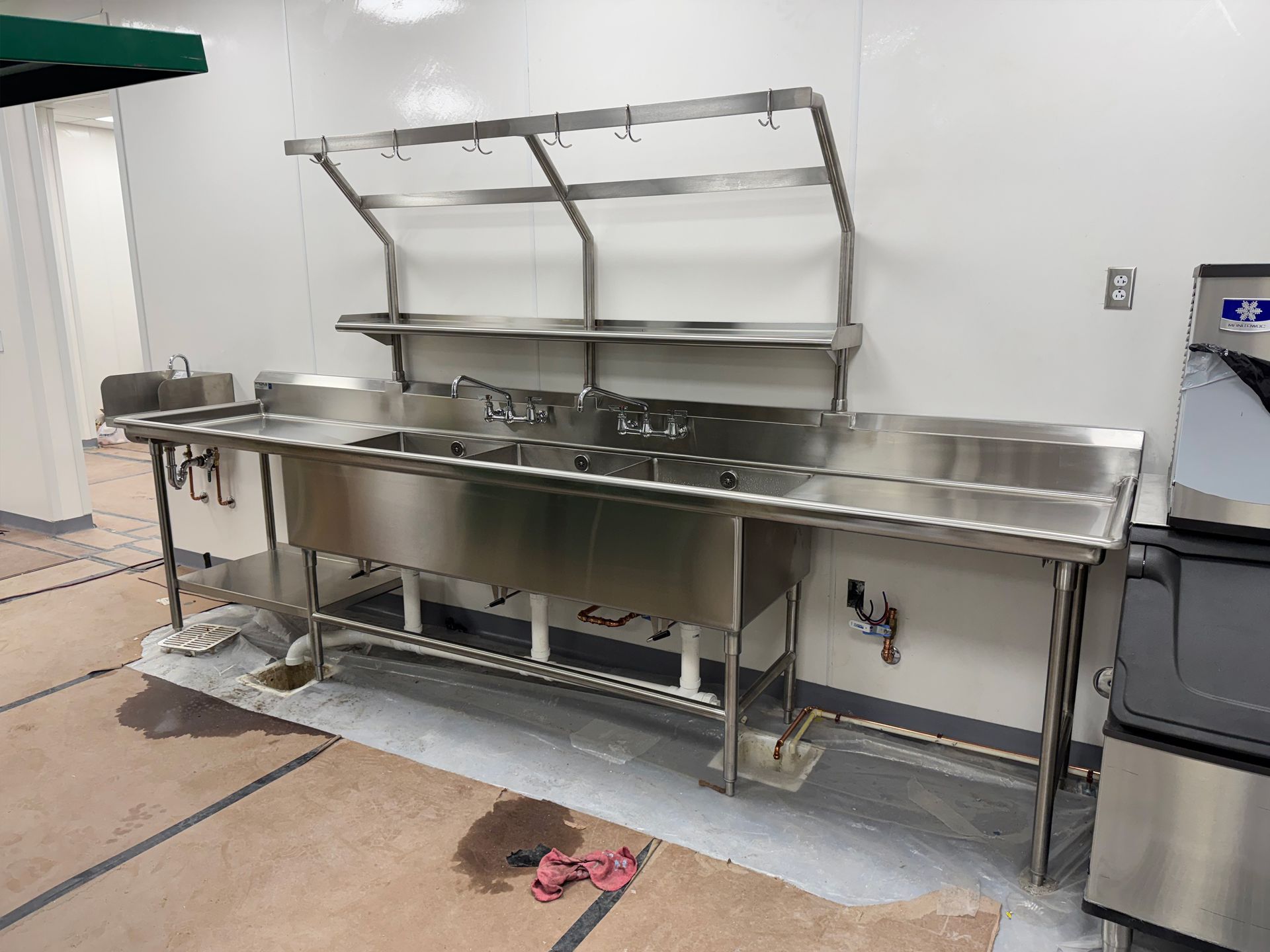 Photo of Three-Well Compartment Sink with Pot Rack Shelf installed at Hugs Cafe