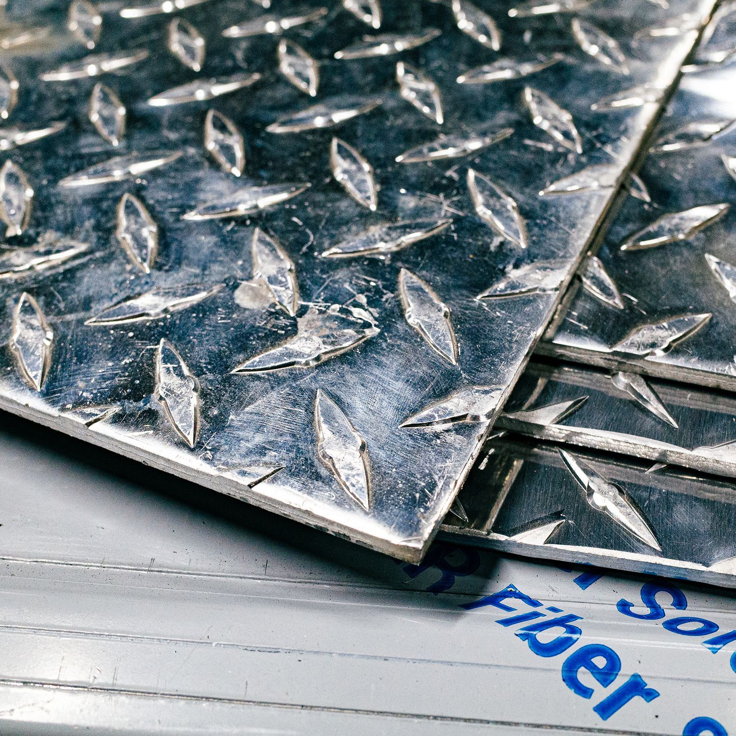 A sheet of metal is sitting on top of a table in the Integrus Fabrication shop.