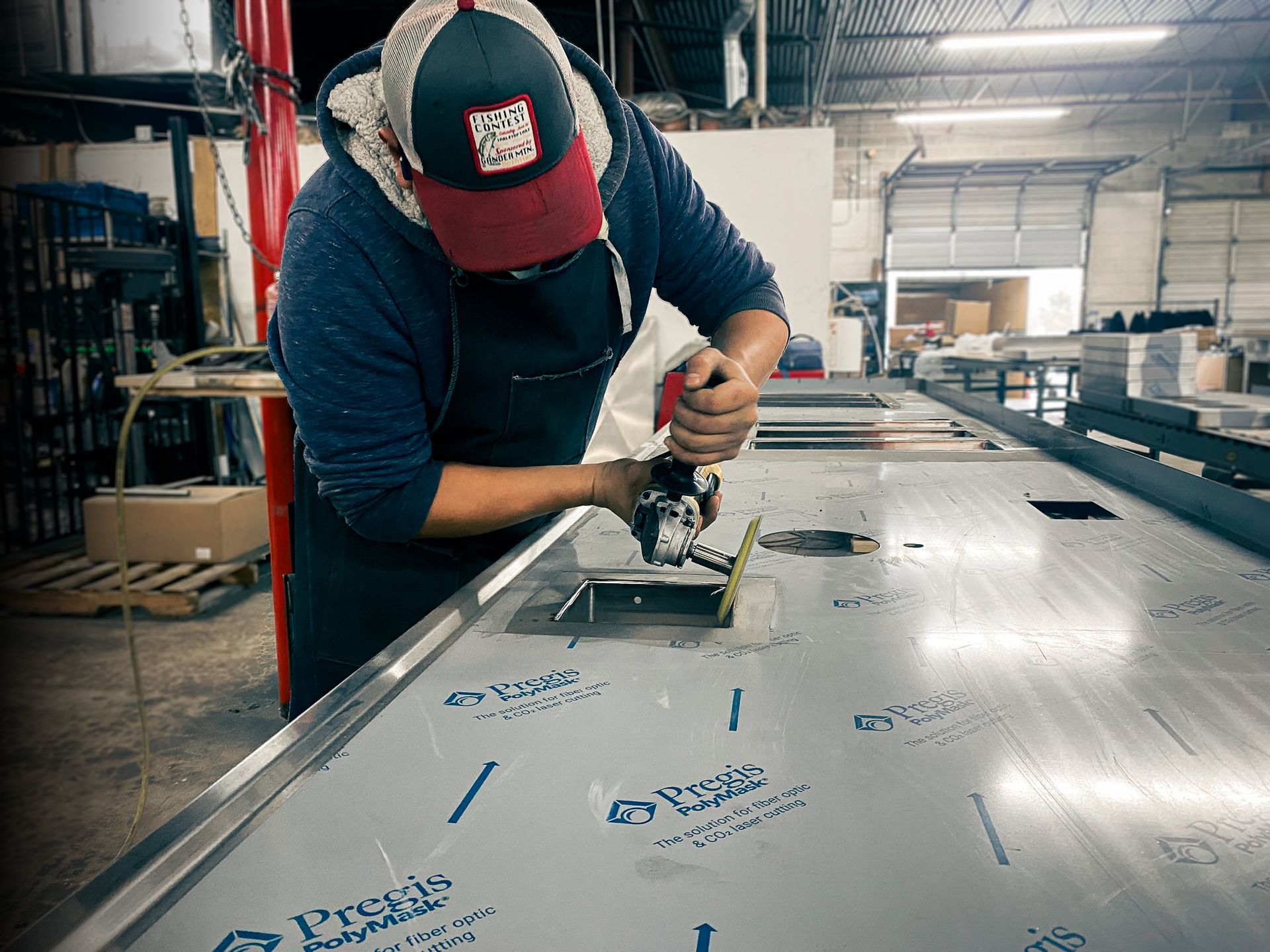 Integrus Fabrication team member polishing Food Service Equipment