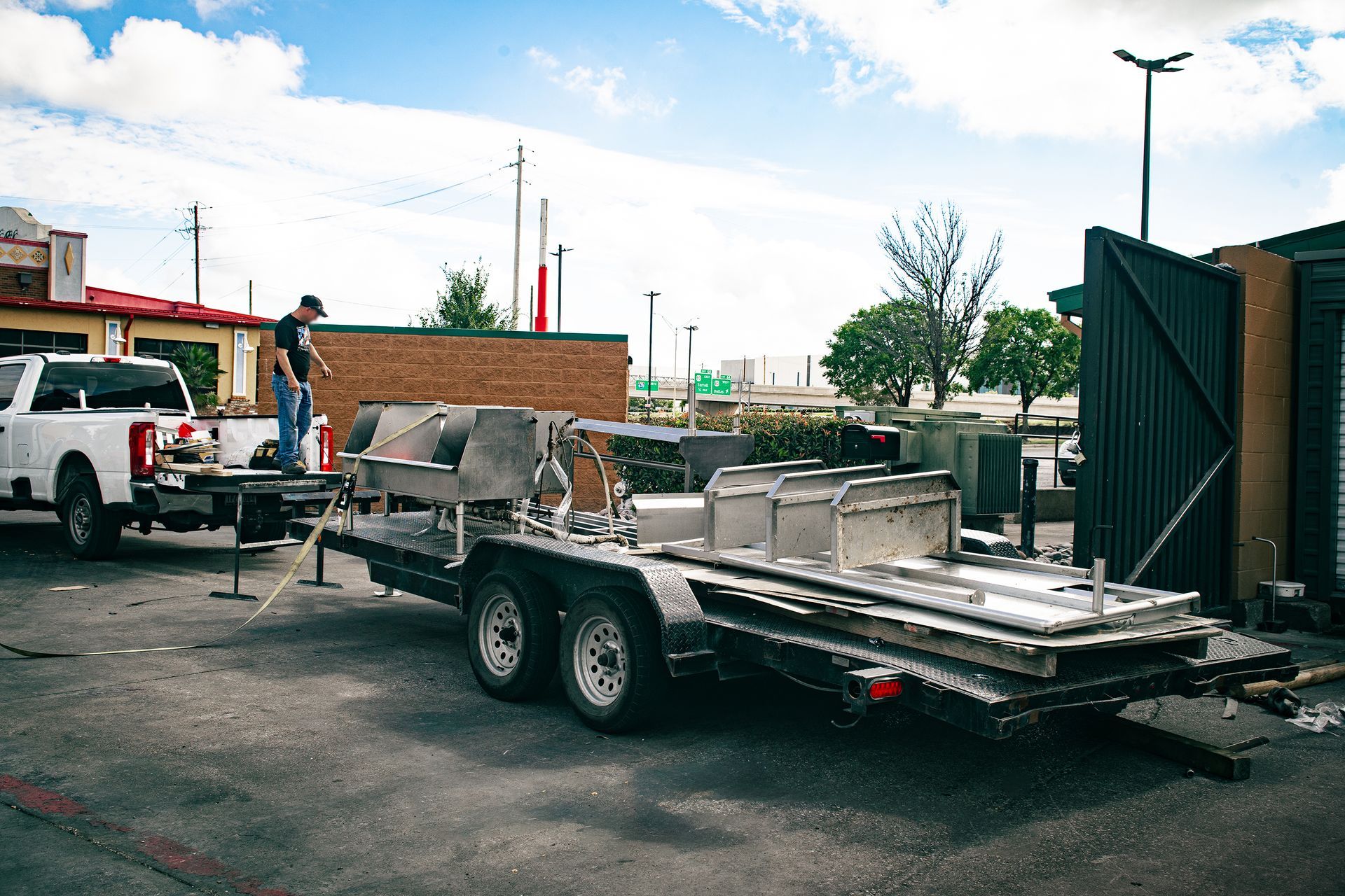Photo of the Integrus Fabrication trailer hauling old equipment