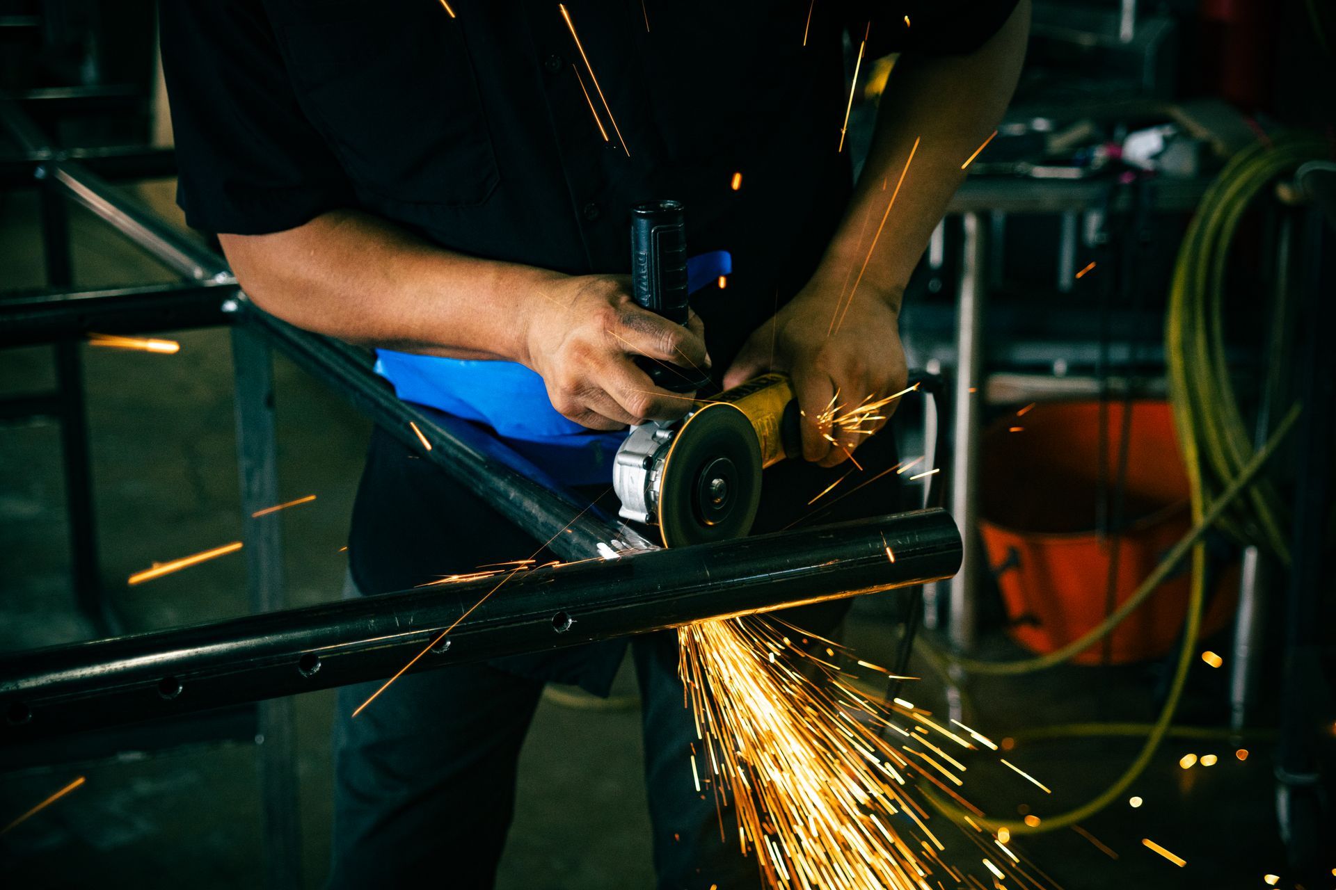 A man polishing/deburring a block of metal
