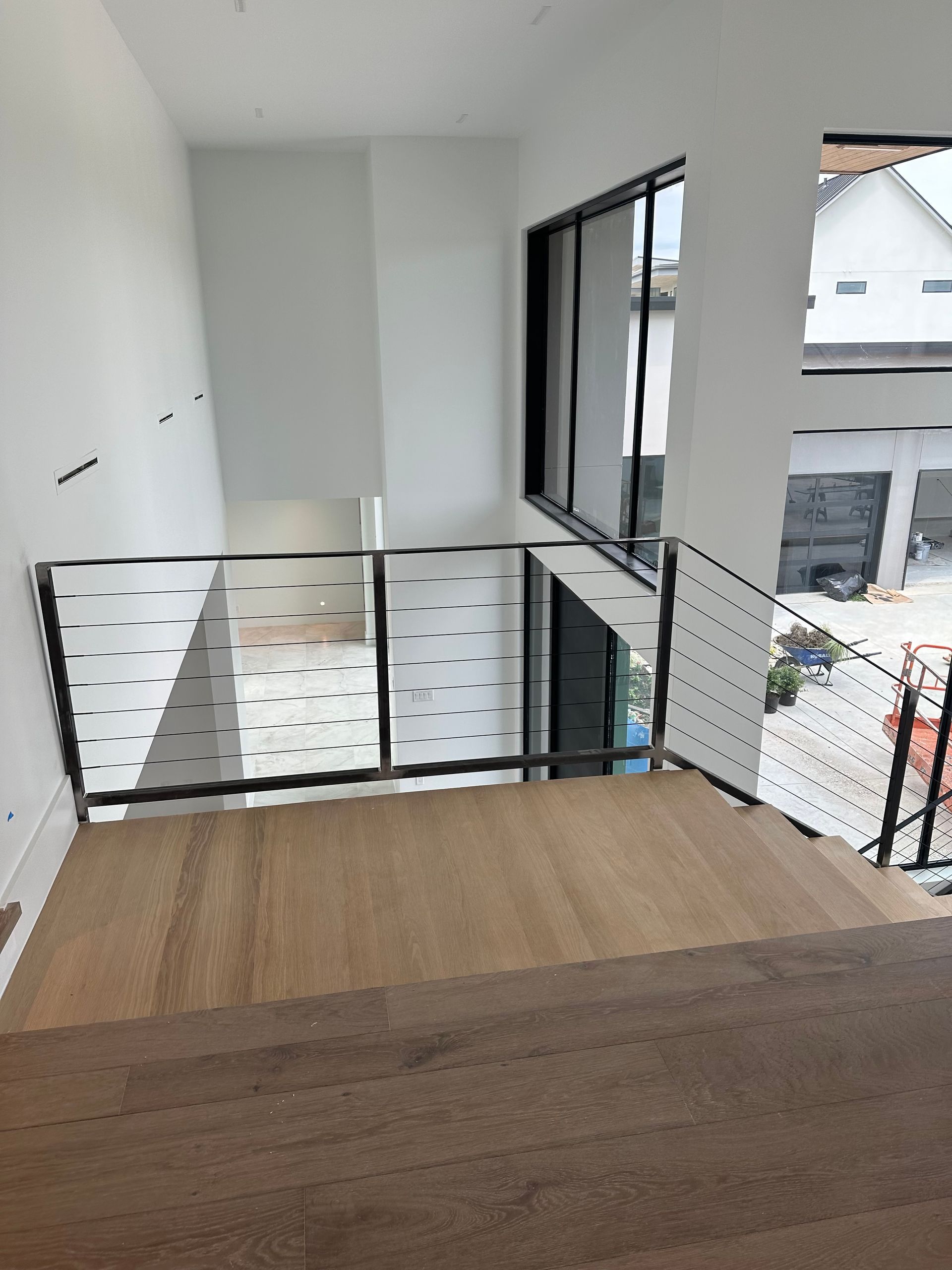 Photo of residential metal fabricated cable railing on staircase top view