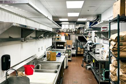 Food Service Equipment A kitchen with stainless steel appliances and a sink.