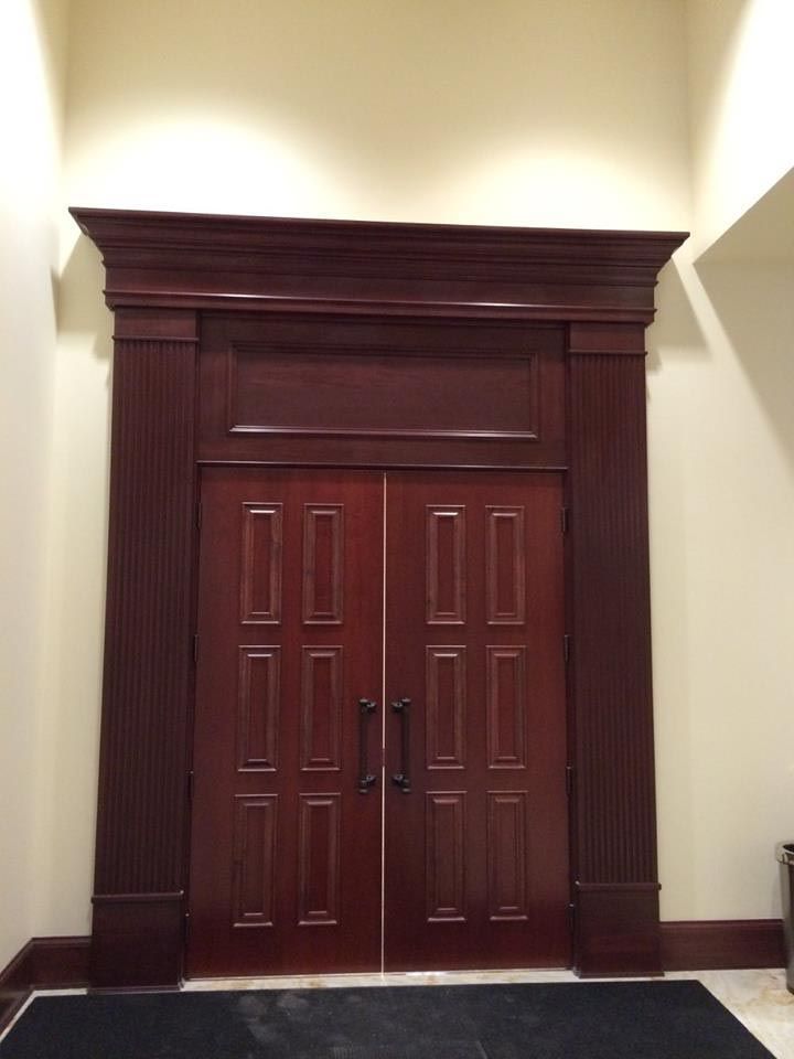 Wooden double doors with dark trim and decorative paneling.