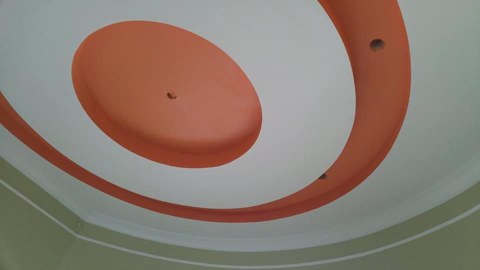 Ceiling with orange oval and curved orange accents against a white background.