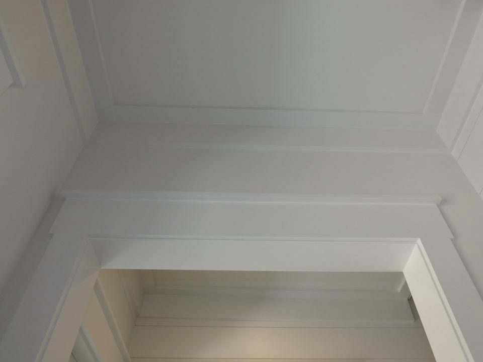 White paneled doorway and ceiling trim in a corner.