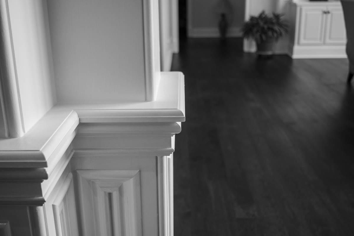 White wall trim with dark wood flooring in a home interior.