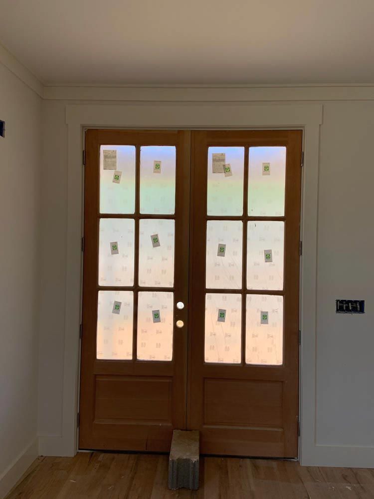 Exterior wood double doors leading to the backyard.