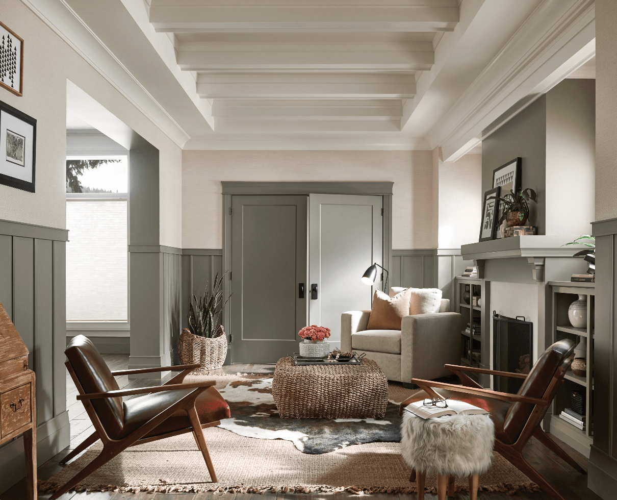 Living room with neutral tones, two chairs, fireplace, and sliding doors.