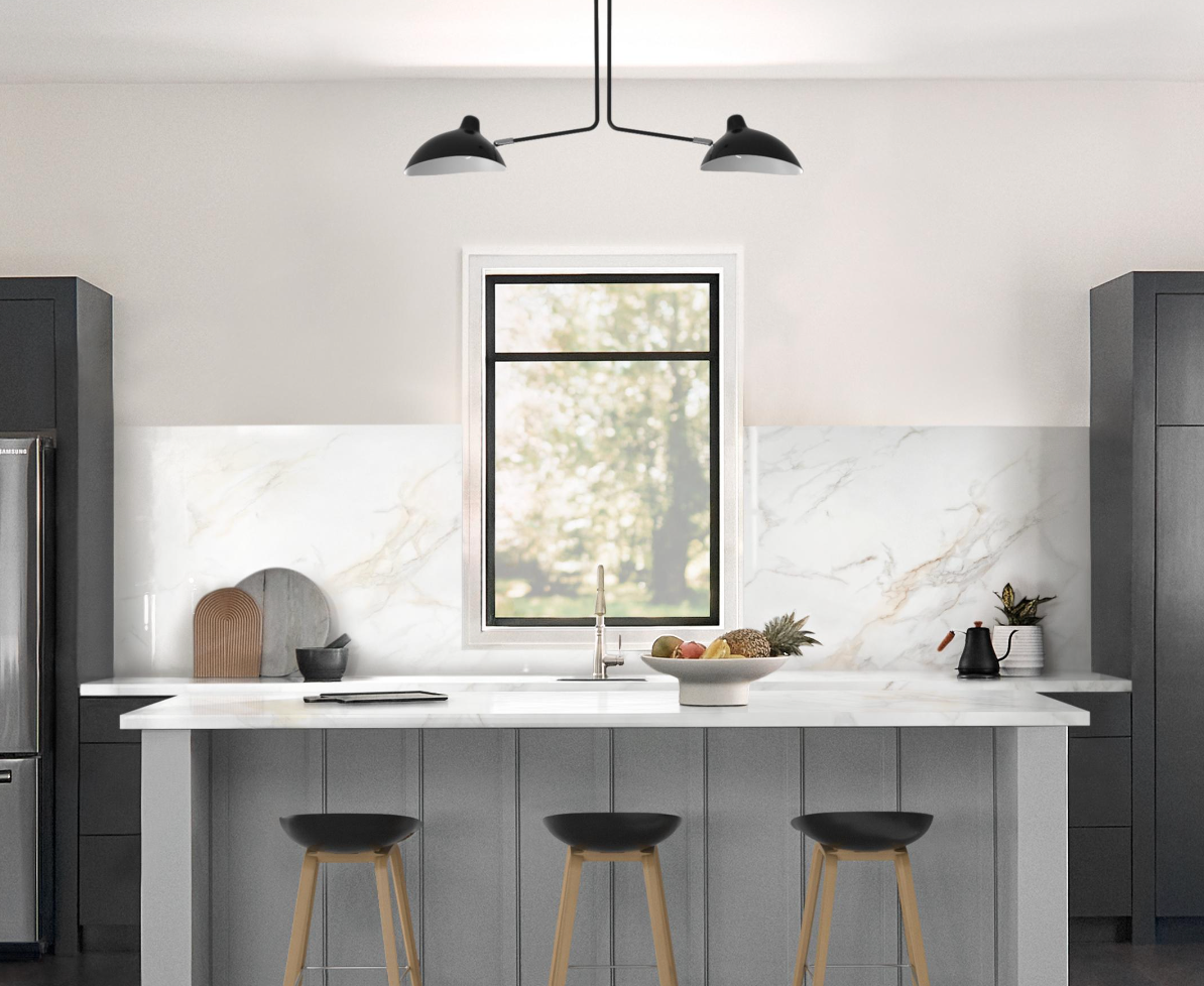 Modern kitchen with marble backsplash, island with stools, and overhead lighting.