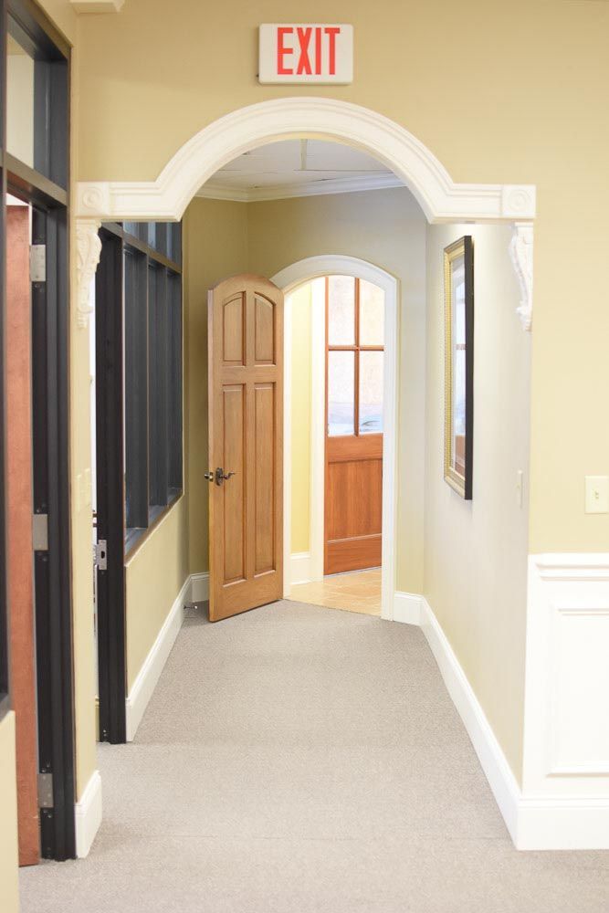 Hallway with open wooden doors, arched doorway, and