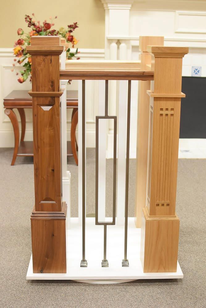 Wooden stair railing with decorative balusters and square posts, showcasing design options.