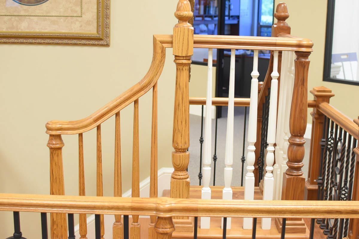 Wooden staircase with decorative spindles and handrails in a home.