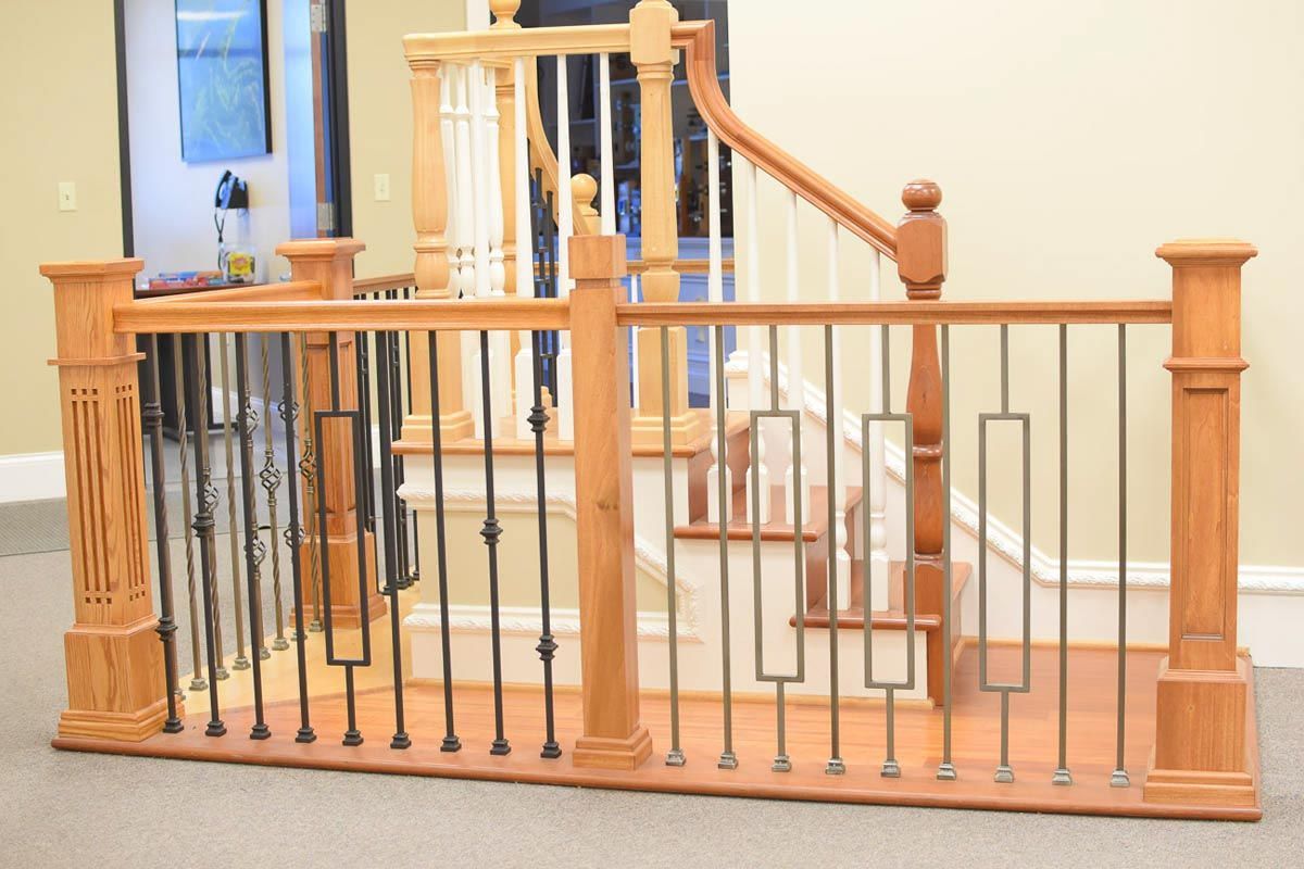 Wooden staircase with decorative iron railings.