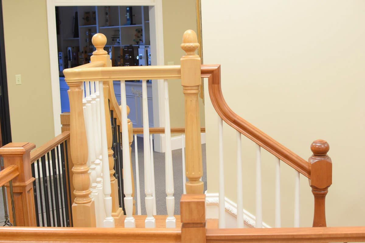 Wooden staircase with light brown and white railings.
