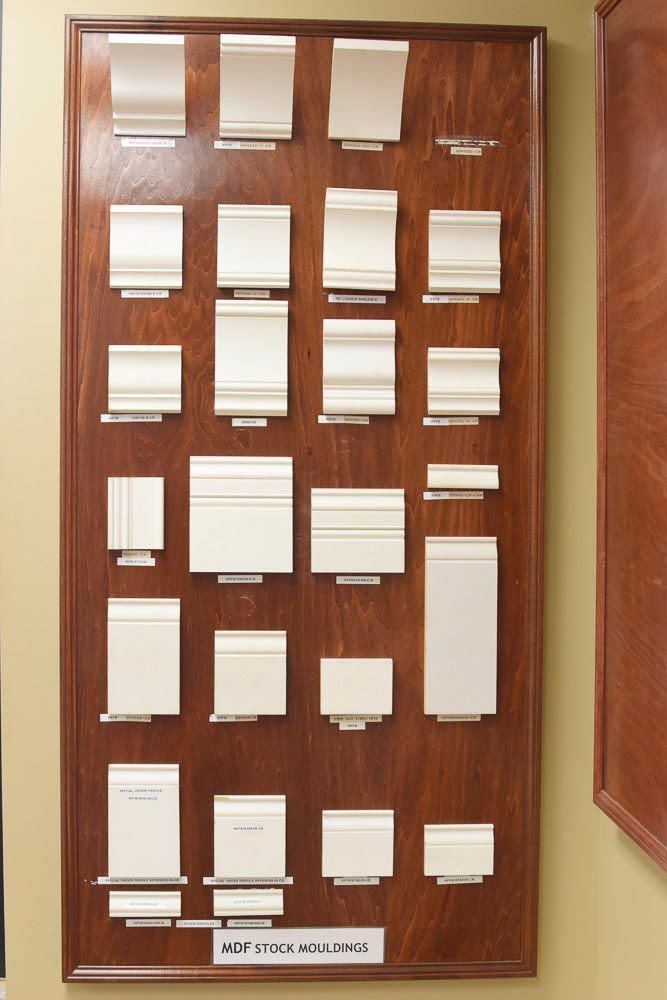 Wood display board with various white molding samples.