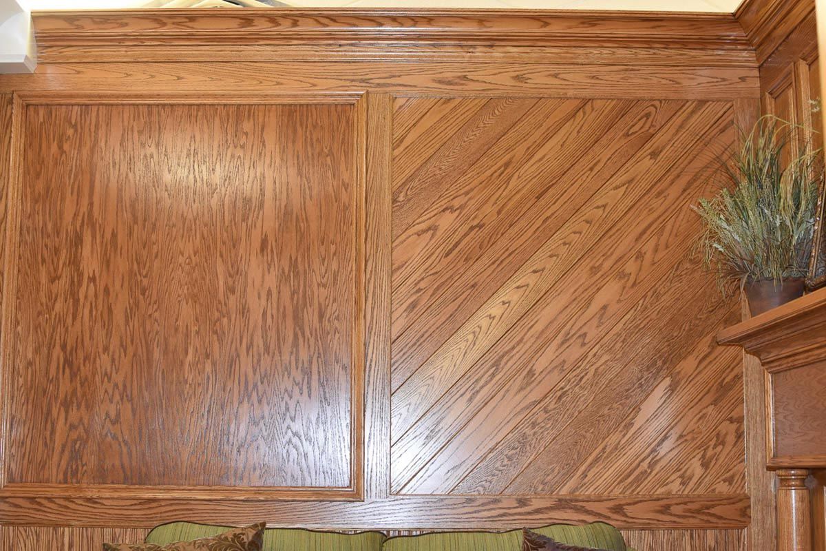 Wood paneling with alternating square and diagonal patterns, stained in a warm brown color.