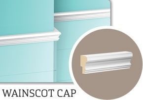 Wainscot cap molding on a teal wall. Close-up of the trim profile in a circle.