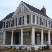 Two-story house with a large covered porch, columns, and dark shutters.