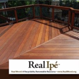 Wooden deck with angled corner, railing, and